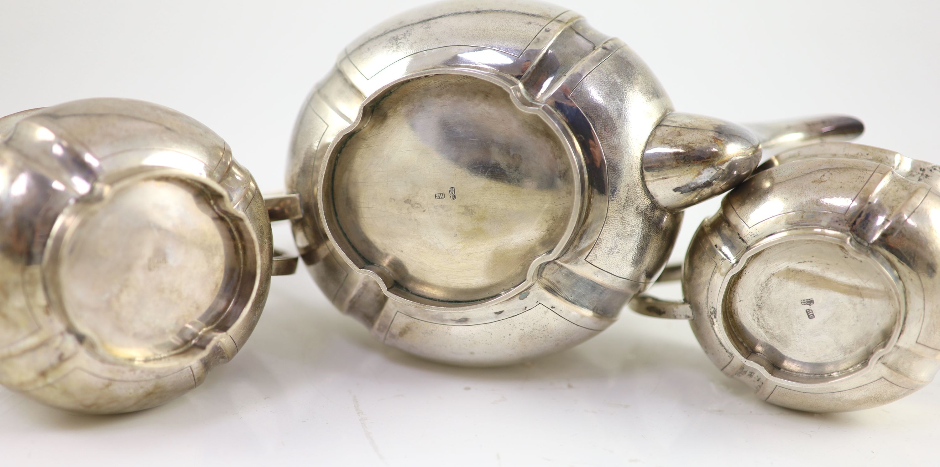 An early 20th century Chinese white metal three piece tea set by Zee Wo